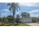 Charming single-story home featuring a two-car garage, complemented by lush landscaping and a vibrant green lawn at 770 Mink Ct, Poinciana, FL 34759