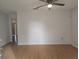 Spacious living room with hardwood floors, ceiling fan, and neutral paint provides a bright, inviting atmosphere at 770 Mink Ct, Poinciana, FL 34759