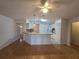 Bright living area featuring hardwood floors, a breakfast bar, and an open layout connecting to the kitchen at 770 Mink Ct, Poinciana, FL 34759