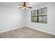 Bright bedroom with ceiling fan and large window at 800 Ebb Tide Ln, Kissimmee, FL 34759