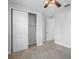 Carpeted Bedroom featuring an open closet with sliding doors and view into the hallway at 800 Ebb Tide Ln, Kissimmee, FL 34759