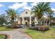 Community clubhouse with covered entrance, palm trees, and brick pavers at 800 Ebb Tide Ln, Kissimmee, FL 34759