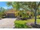 Single-story home boasts a brick driveway and lush landscaping adding curb appeal at 800 Ebb Tide Ln, Kissimmee, FL 34759