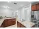 L-shaped kitchen with granite countertops and stainless steel appliances at 800 Ebb Tide Ln, Kissimmee, FL 34759
