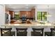 Modern kitchen featuring granite countertops, stainless steel appliances, and a breakfast bar at 800 Ebb Tide Ln, Kissimmee, FL 34759