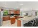 Spacious kitchen with wood cabinets, an island, granite countertops, and open layout at 800 Ebb Tide Ln, Kissimmee, FL 34759