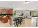 Open-concept kitchen with granite countertops, seating, and stainless steel appliances at 800 Ebb Tide Ln, Kissimmee, FL 34759