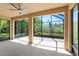 A screened lanai with ceiling fan and view into the beautiful backyard at 800 Ebb Tide Ln, Kissimmee, FL 34759