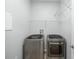 Bright laundry room with washer, dryer, and ample shelving at 800 Ebb Tide Ln, Kissimmee, FL 34759
