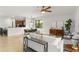 Spacious living room that flows into the dining area and showcases the open kitchen with stainless steel appliances at 800 Ebb Tide Ln, Kissimmee, FL 34759