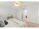 Angle view of a carpeted primary bedroom leading to the bathroom with a ceiling fan and light fixture at 800 Ebb Tide Ln, Kissimmee, FL 34759
