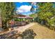 Landscaped backyard with patio, grass, and lush greenery at 805 Wingo St, Orlando, FL 32803