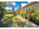 Landscaped backyard with a brick pathway and grassy area at 805 Wingo St, Orlando, FL 32803