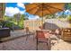 Relaxing brick patio with seating area, umbrella, and lush landscaping at 805 Wingo St, Orlando, FL 32803