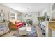 Living room with a mustard couch and patterned rug at 805 Wingo St, Orlando, FL 32803