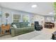 Relaxing living room featuring a green sofa and recliner at 805 Wingo St, Orlando, FL 32803