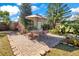 Brick patio with a table, chairs, and an umbrella, near a shed at 805 Wingo St, Orlando, FL 32803