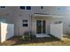 A home's backyard with a small patio area, a sliding glass door, and a privacy fence at 9088 Ocean Tide Way, Kissimmee, FL 34747