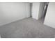 Bright, carpeted bedroom with neutral walls, two closets and a view into another room at 9088 Ocean Tide Way, Kissimmee, FL 34747