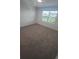 Bedroom featuring a carpet floor, one window with blinds providing natural light, and neutral walls at 9088 Ocean Tide Way, Kissimmee, FL 34747