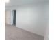 Bright, carpeted bedroom with neutral walls, doorway, and a view into another room at 9088 Ocean Tide Way, Kissimmee, FL 34747