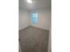 Carpeted bedroom with a window and blinds, offering natural light and a view at 9088 Ocean Tide Way, Kissimmee, FL 34747