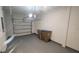 Spacious garage featuring a gray epoxy floor, a partially opened garage door, and white block walls at 9088 Ocean Tide Way, Kissimmee, FL 34747