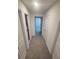 Bright hallway with neutral carpet and white walls leading to various rooms in the home at 9088 Ocean Tide Way, Kissimmee, FL 34747