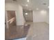 Open living area featuring tile floors, neutral walls, recessed lighting, with a view of the kitchen and entryway at 9088 Ocean Tide Way, Kissimmee, FL 34747