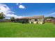 Spacious backyard with grassy lawn and home view at 6655 Durango Ct, Orlando, FL 32809