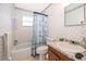 Bathroom with a shower/tub combo and seashell wallpaper at 6655 Durango Ct, Orlando, FL 32809