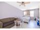 Bright bedroom with a queen-size bed, sofa, and small table at 6655 Durango Ct, Orlando, FL 32809
