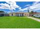 Ranch-style home with a spacious lawn and driveway at 6655 Durango Ct, Orlando, FL 32809
