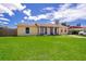 Ranch-style home with a spacious lawn and driveway at 6655 Durango Ct, Orlando, FL 32809