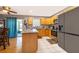 Kitchen with an island, wooden cabinets, and modern appliances at 6655 Durango Ct, Orlando, FL 32809
