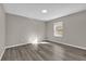 Well-lit bedroom featuring wood-look floors and a window at 10842 Sw 67Th Ave, Ocala, FL 34476