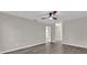 Simple bedroom with wood-look floors and an open doorway at 10842 Sw 67Th Ave, Ocala, FL 34476
