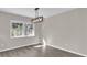 Spacious dining area with wood-look floors and a modern light fixture at 10842 Sw 67Th Ave, Ocala, FL 34476