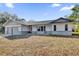 Newly constructed one-story home with gray siding, attached garage, and spacious lawn at 10842 Sw 67Th Ave, Ocala, FL 34476