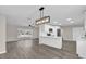 Open concept kitchen with white shaker cabinets and a large island at 10842 Sw 67Th Ave, Ocala, FL 34476