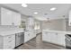 Modern kitchen with white cabinets, a large island, and stainless steel appliances at 10842 Sw 67Th Ave, Ocala, FL 34476