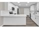 Modern kitchen with white cabinets, stainless steel appliances, and quartz countertops at 10842 Sw 67Th Ave, Ocala, FL 34476