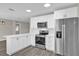 Modern kitchen with white cabinets, quartz countertops, and stainless steel appliances at 10842 Sw 67Th Ave, Ocala, FL 34476