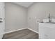 Bright laundry room with utility sink and modern flooring at 10842 Sw 67Th Ave, Ocala, FL 34476