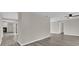 Open living area with gray walls, wood-look floors, and views to other rooms at 10842 Sw 67Th Ave, Ocala, FL 34476