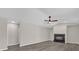 Spacious living room featuring a fireplace and ceiling fan at 10842 Sw 67Th Ave, Ocala, FL 34476