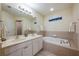 Bathroom with double sinks and a garden tub at 111 Vista Dr, Davenport, FL 33897