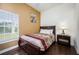 Bedroom with a double bed, nightstand, and window with blinds at 111 Vista Dr, Davenport, FL 33897