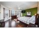 Spacious main bedroom with wood floors, large windows, and a king-size bed at 111 Vista Dr, Davenport, FL 33897