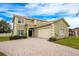 Two-story house with a large driveway and a two-car garage at 111 Vista Dr, Davenport, FL 33897